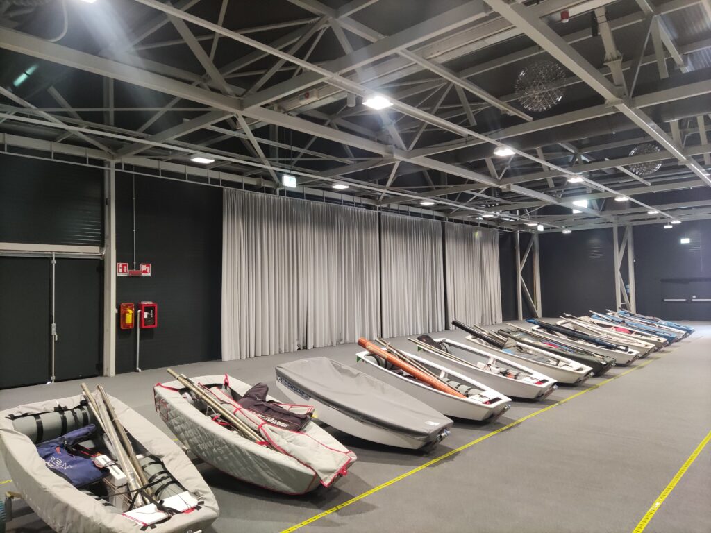 optimist sailboats in storage